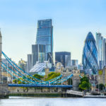 Tower bridge and financial district of London with a cloudless sky at sunset